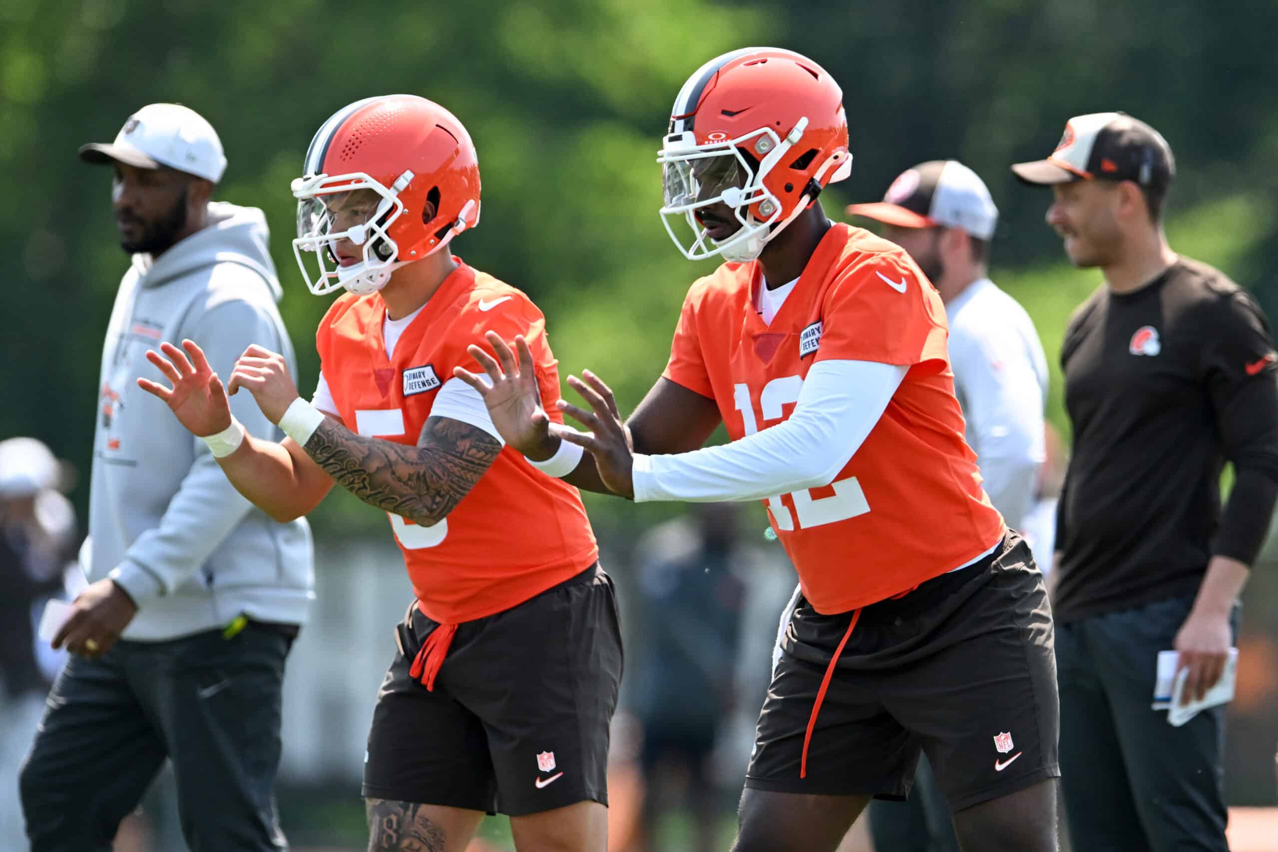 BEREA, OHIO - JUNE 11: Shedeur Sanders #12 and Dillon Gabriel #5 of the Cleveland Browns run a drill during Cleveland Browns mandatory minicamp at CrossCountry Mortgage Campus on June 11, 2025 in Berea, Ohio.