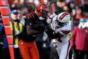 CINCINNATI, OHIO - DECEMBER 22: Tee Higgins #5 of the Cincinnati Bengals is tackled by Denzel Ward #21 of the Cleveland Browns during the first quarter at Paycor Stadium on December 22, 2024 in Cincinnati, Ohio.