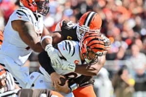 CLEVELAND, OHIO - SEPTEMBER 07: Joe Burrow #9 of the Cincinnati Bengals is sacked by Myles Garrett #95 of the Cleveland Browns during the fourth quarter against the Cleveland Browns during the game at Huntington Bank Field on September 07, 2025 in Cleveland, Ohio.