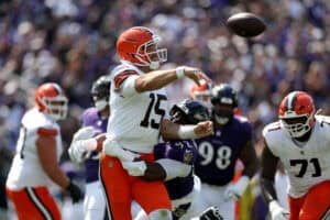BALTIMORE, MARYLAND - SEPTEMBER 14: Quarterback Joe Flacco #15 of the Cleveland Browns is pressured by defensive tackle Nnamdi Madubuike #92 of the Baltimore Ravens at M&T Bank Stadium on September 14, 2025 in Baltimore, Maryland.