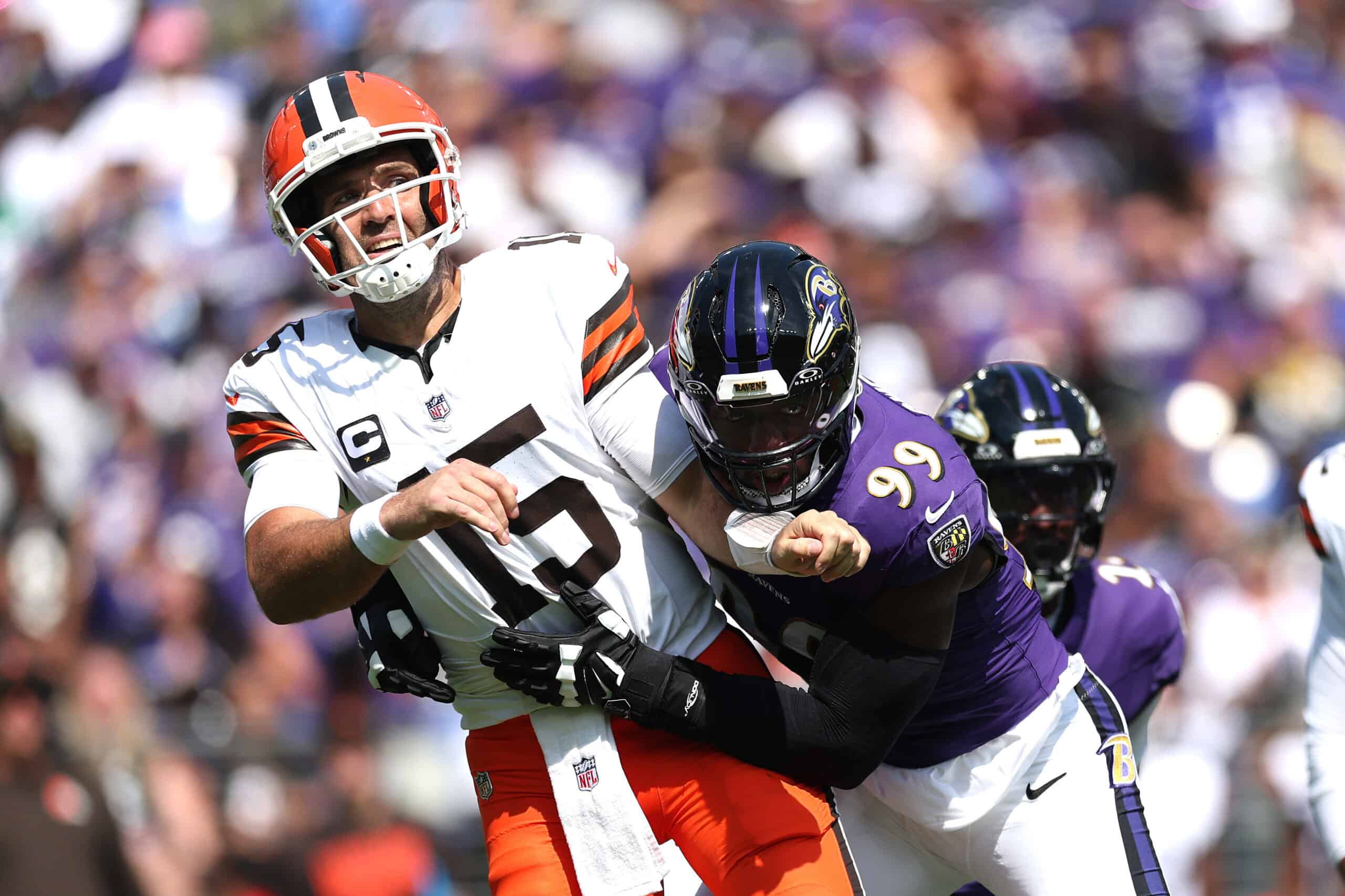 BALTIMORE, MARYLAND - SEPTEMBER 14: Joe Flacco #15 of the Cleveland Browns is rushed by Odafe Oweh #99 of the Baltimore Ravens during the game at M&T Bank Stadium on September 14, 2025 in Baltimore, Maryland.
