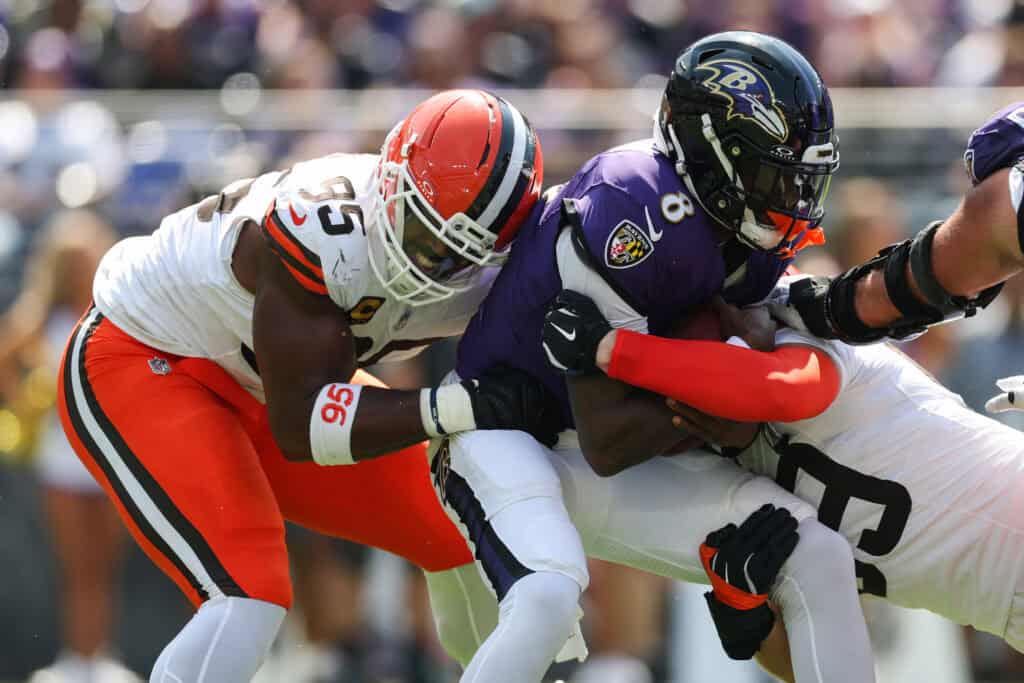 BALTIMORE, MARYLAND - SEPTEMBER 14: Cameron Thomas #99 and Myles Garrett #95 of the Cleveland Browns sack Lamar Jackson #8 of the Baltimore Ravens during the first quarter at M&T Bank Stadium on September 14, 2025 in Baltimore, Maryland.