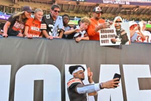 CLEVELAND, OHIO - SEPTEMBER 07: Greg Newsome II #0 of the Cleveland Browns poses for a photo with fans after the game against the Cincinnati Bengals during the game at Huntington Bank Field on September 07, 2025 in Cleveland, Ohio.