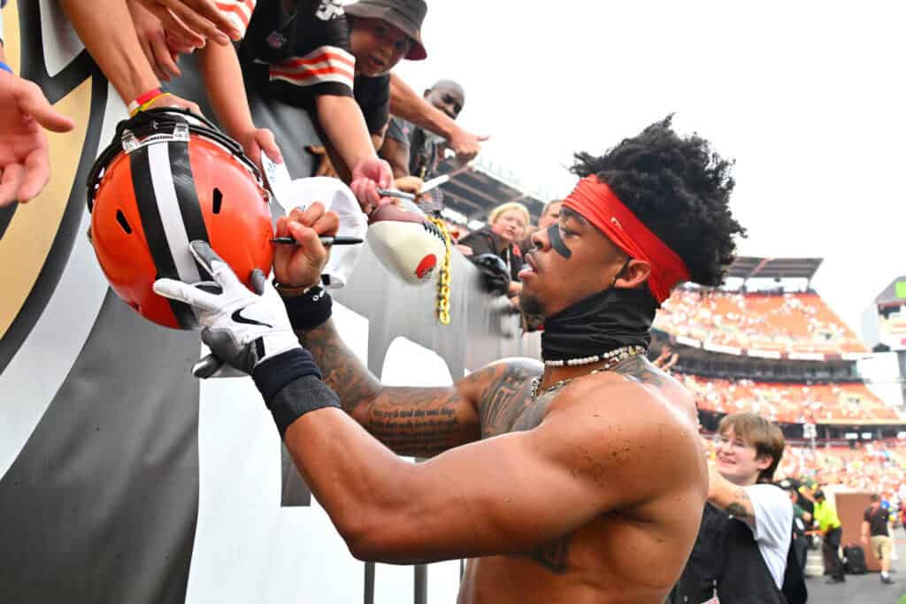 CLEVELAND, OHIO - SEPTEMBER 21: Greg Newsome II #0 of the Cleveland Browns signs autographs after the game against the Green Bay Packers at Huntington Bank Field on September 21, 2025 in Cleveland, Ohio.