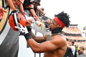 CLEVELAND, OHIO - SEPTEMBER 21: Greg Newsome II #0 of the Cleveland Browns signs autographs after the game against the Green Bay Packers at Huntington Bank Field on September 21, 2025 in Cleveland, Ohio.