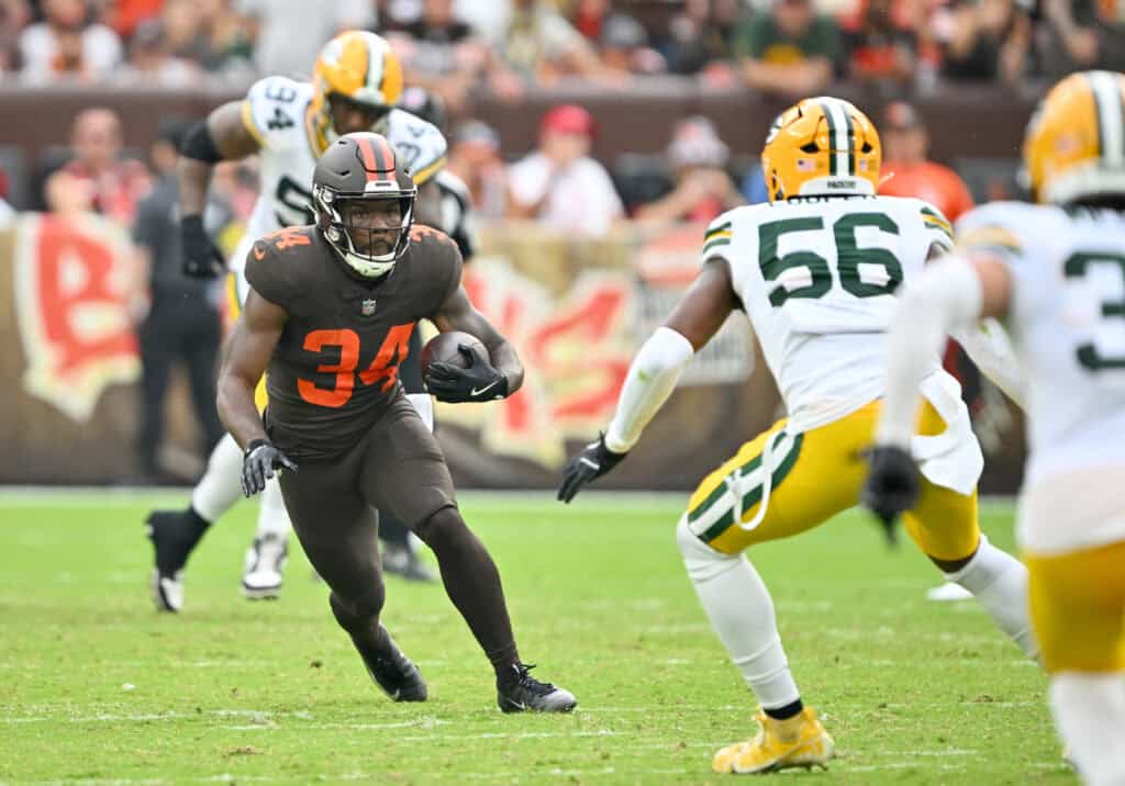 CLEVELAND, OHIO - SEPTEMBER 21: Jerome Ford #34 of the Cleveland Browns runs the ball against Edgerrin Cooper #56 of the Green Bay Packers at Huntington Bank Field on September 21, 2025 in Cleveland, Ohio.