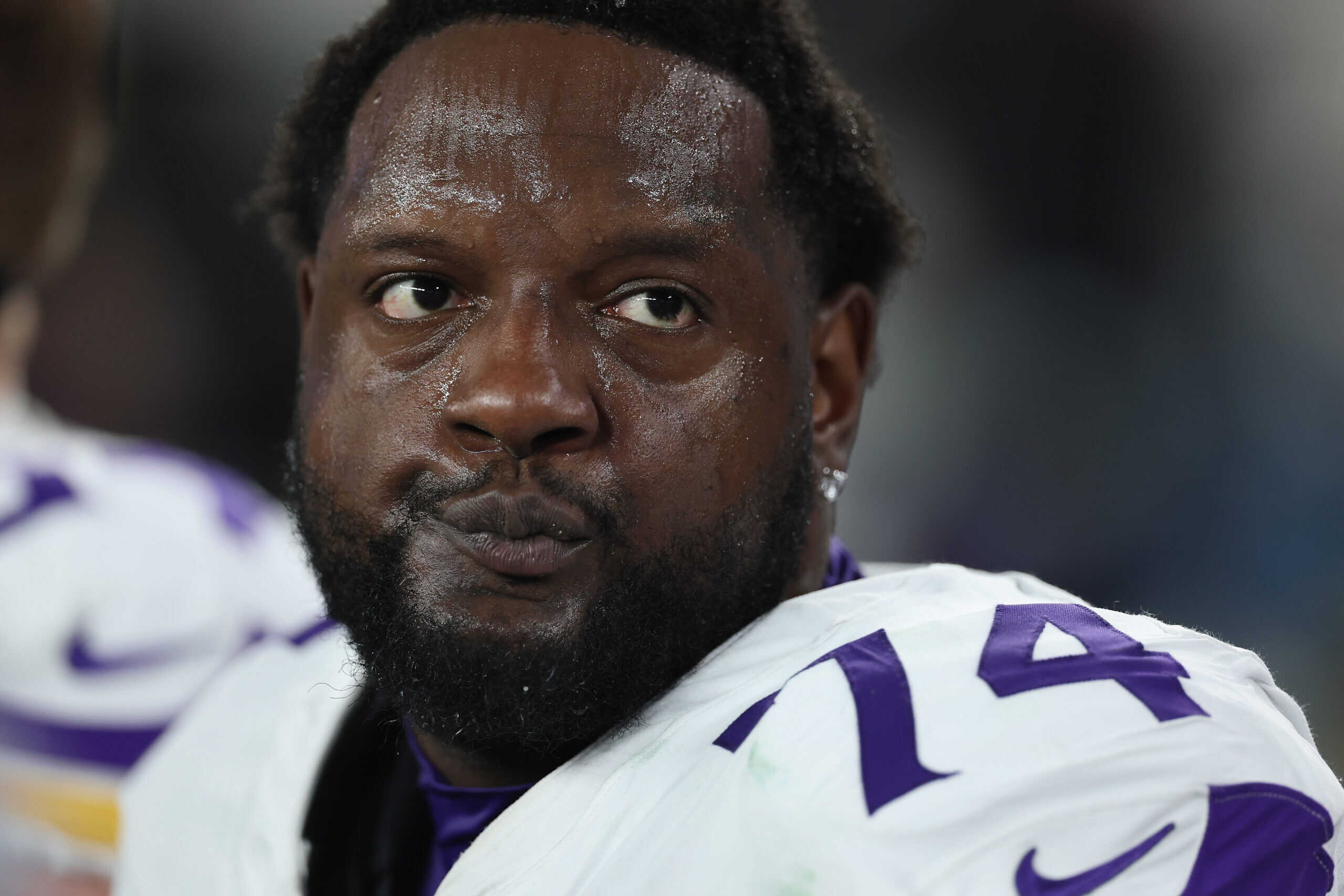 GLENDALE, ARIZONA - JANUARY 13: Cam Robinson #74 of the Minnesota Vikings sits on the bench during the NFL playoff game at State Farm Stadium on January 13, 2025 in Glendale, Arizona. The Rams defeated the Vikings 27-9