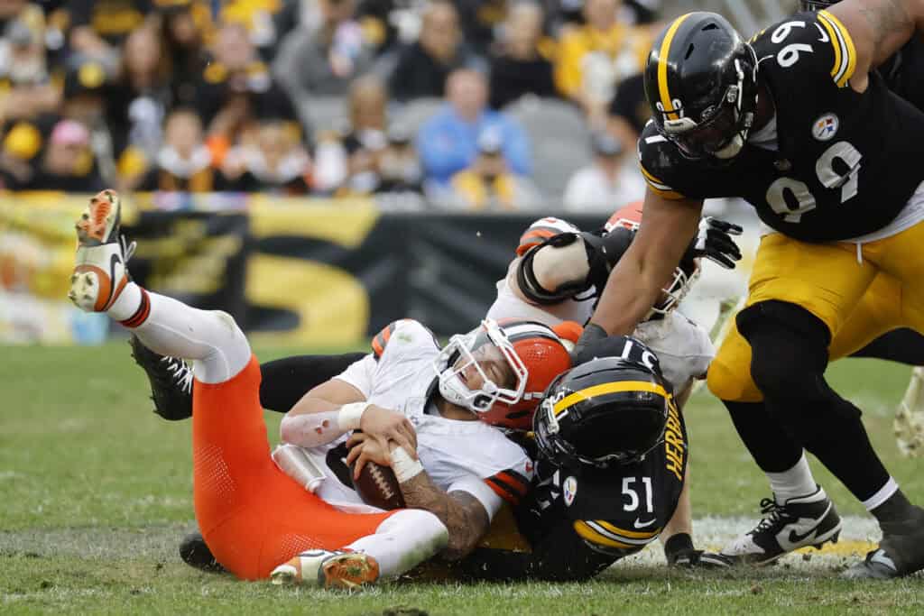 PITTSBURGH, PENNSYLVANIA - OCTOBER 12: Dillon Gabriel #8 of the Cleveland Browns is sacked by Nick Herbig #51 of the Pittsburgh Steelers during the fourth quarter in the game at Acrisure Stadium on October 12, 2025 in Pittsburgh, Pennsylvania.