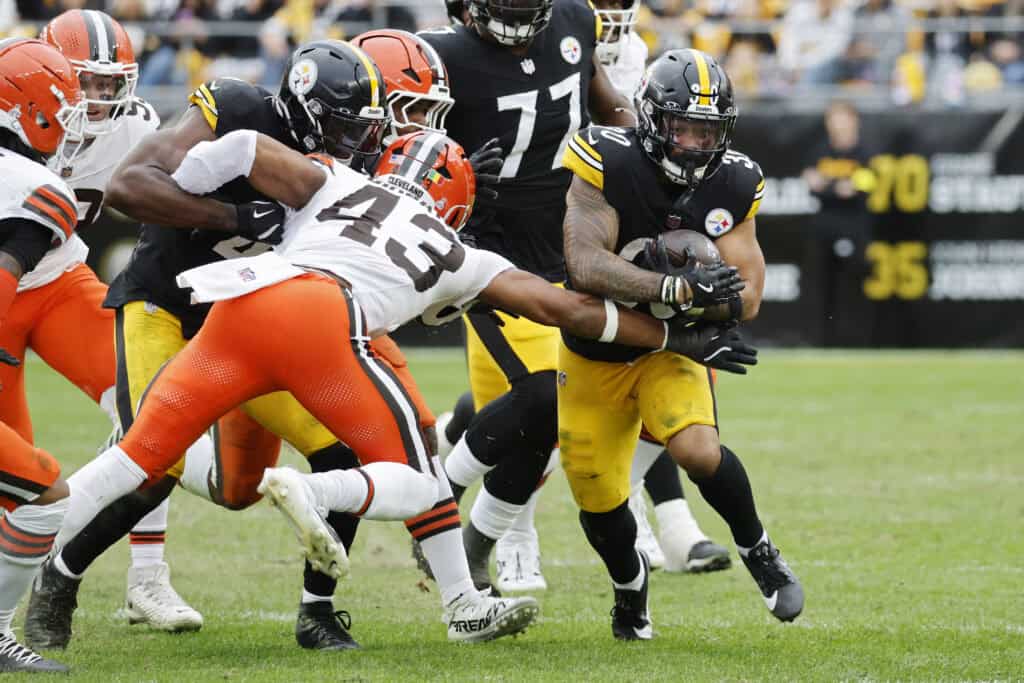 PITTSBURGH, PENNSYLVANIA - OCTOBER 12: Jaylen Warren #30 of the Pittsburgh Steelers runs against Mohamoud Diabate #43 of the Cleveland Browns during the third quarter in the game at Acrisure Stadium on October 12, 2025 in Pittsburgh, Pennsylvania.