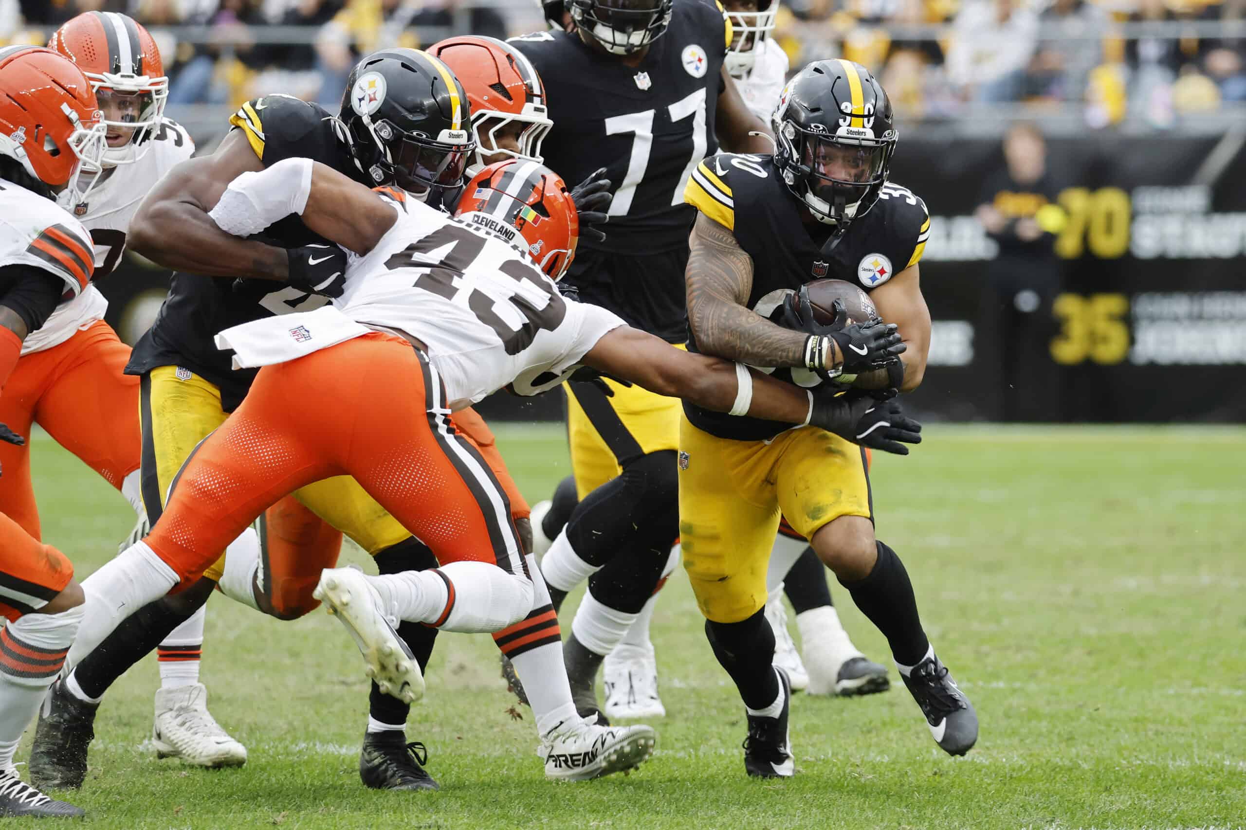 PITTSBURGH, PENNSYLVANIA - OCTOBER 12: Jaylen Warren #30 of the Pittsburgh Steelers runs against Mohamoud Diabate #43 of the Cleveland Browns during the third quarter in the game at Acrisure Stadium on October 12, 2025 in Pittsburgh, Pennsylvania.