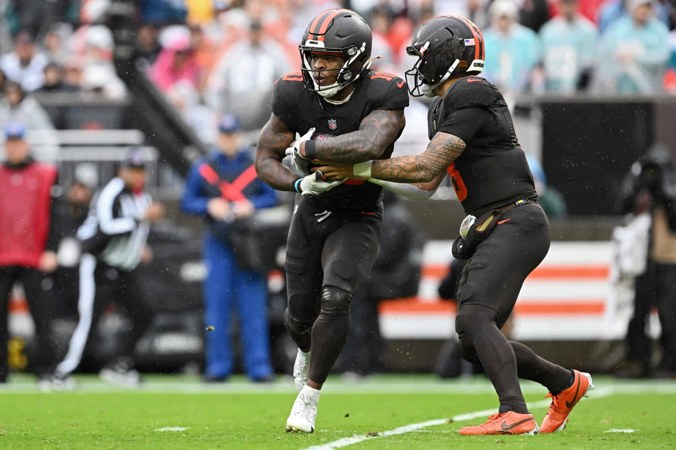 CLEVELAND, OHIO - OCTOBER 19: Dillon Gabriel #8 of the Cleveland Browns hands off the ball to teammate Quinshon Judkins #10 during the second quarter against the Miami Dolphins at Huntington Bank Field on October 19, 2025 in Cleveland, Ohio.