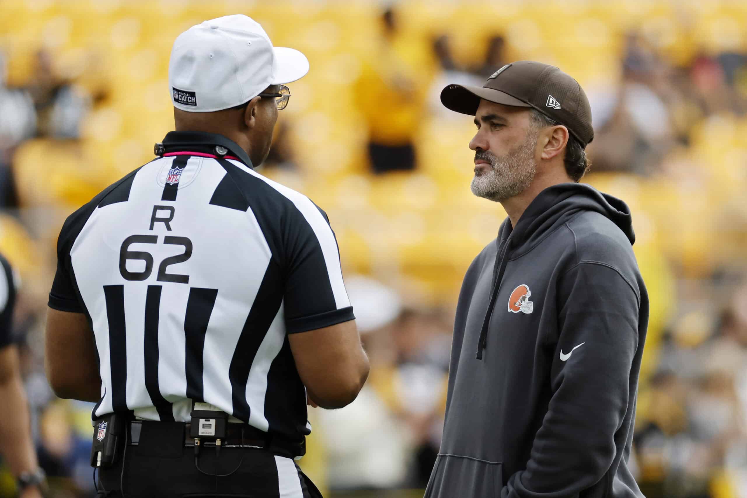 PITTSBURGH, PENNSYLVANIA - OCTOBER 12: Head coach Kevin Stefanski of the Cleveland Browns talks with referee Ron Torbert #62 before the game against the Pittsburgh Steelers at Acrisure Stadium on October 12, 2025 in Pittsburgh, Pennsylvania.