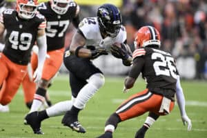 CLEVELAND, OHIO - NOVEMBER 16: Derrick Henry #22 of the Baltimore Ravens carries the ball defended by Myles Harden #26 of the Cleveland Browns during the first quarter at Huntington Bank Field on November 16, 2025 in Cleveland, Ohio.