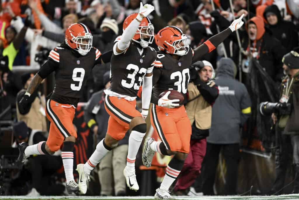 CLEVELAND, OHIO - NOVEMBER 16: Devin Bush #30 of the Cleveland Browns celebrates a touchdown after an interception against the Baltimore Ravens with teammates Grant Delpit #9 and Ronnie Hickman #33 during the second quarter at Huntington Bank Field on November 16, 2025 in Cleveland, Ohio.