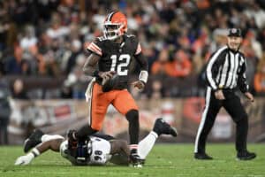 CLEVELAND, OHIO - NOVEMBER 16: Shedeur Sanders #12 of the Cleveland Browns scrambles with the ball against the Baltimore Ravens during the fourth quarter at Huntington Bank Field on November 16, 2025 in Cleveland, Ohio.