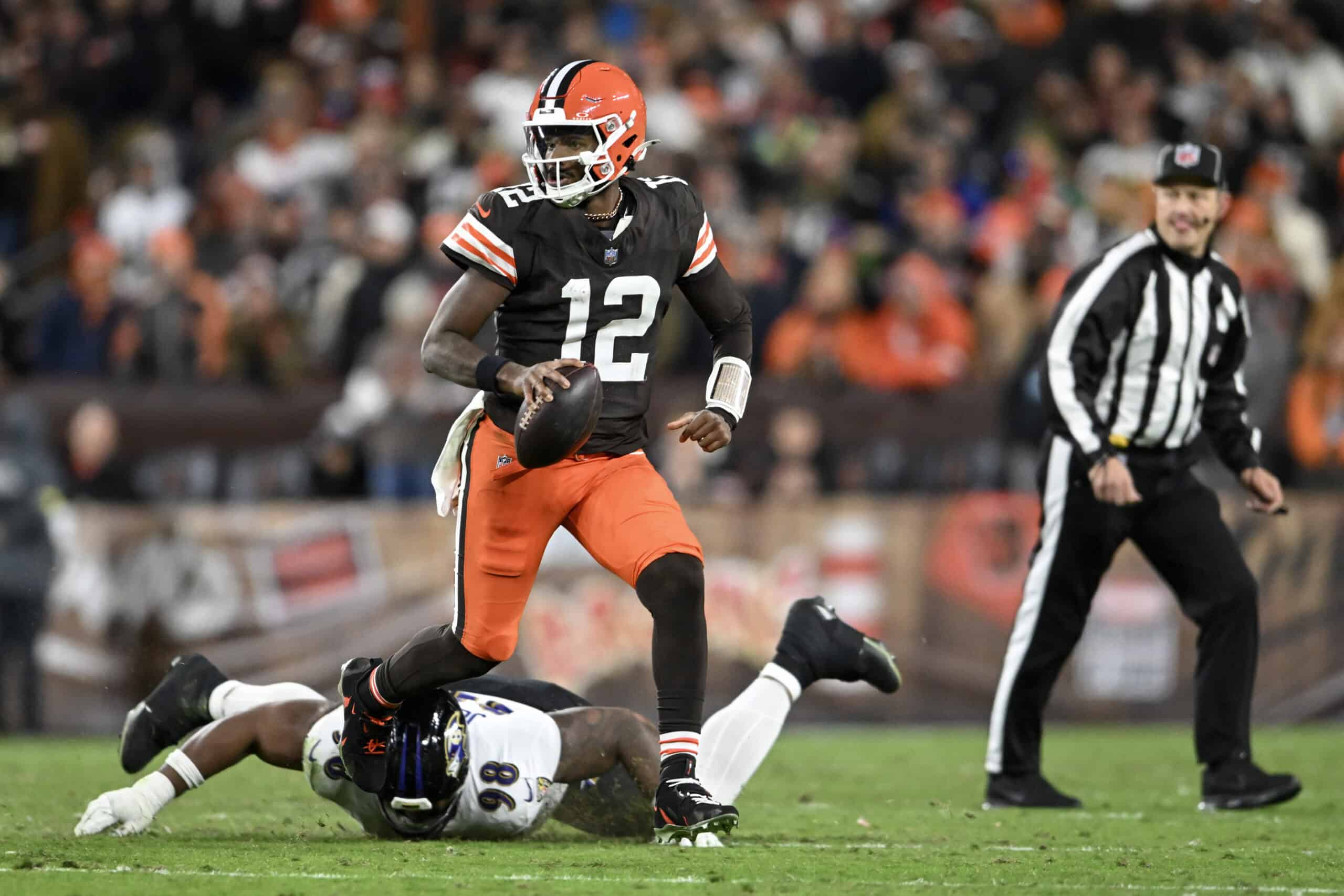 CLEVELAND, OHIO - NOVEMBER 16: Shedeur Sanders #12 of the Cleveland Browns scrambles with the ball against the Baltimore Ravens during the fourth quarter at Huntington Bank Field on November 16, 2025 in Cleveland, Ohio.