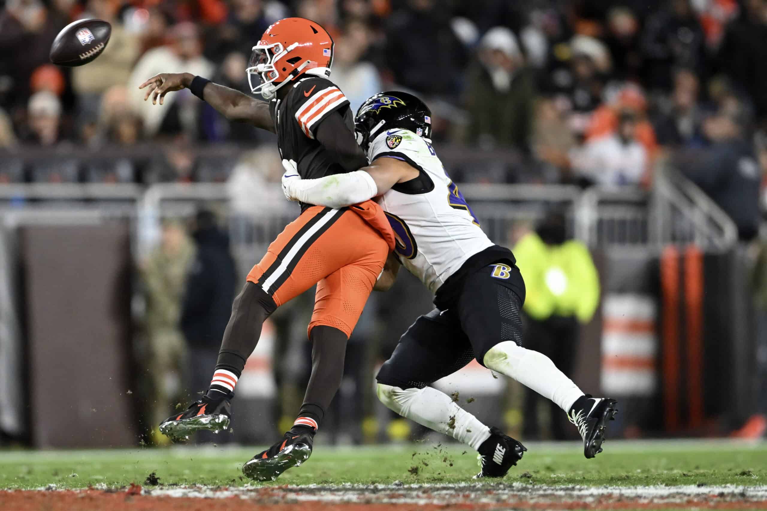CLEVELAND, OHIO - NOVEMBER 16: Shedeur Sanders #12 of the Cleveland Browns passes the ball under pressure from Teddye Buchanan #40 of the Baltimore Ravens during the fourth quarter at Huntington Bank Field on November 16, 2025 in Cleveland, Ohio.