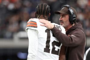 LAS VEGAS, NEVADA - NOVEMBER 23: Head coach Kevin Stefanski talks to Shedeur Sanders #12 of the Cleveland Browns during the first quarter against the Las Vegas Raiders at Allegiant Stadium on November 23, 2025 in Las Vegas, Nevada.