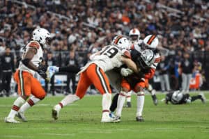 LAS VEGAS, NEVADA - NOVEMBER 23: Ian Thomas #80 of the Las Vegas Raiders is tackled by Carson Schwesinger #49 of the Cleveland Browns in the fourth quarter of a game at Allegiant Stadium on November 23, 2025 in Las Vegas, Nevada.