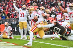 CLEVELAND, OHIO - NOVEMBER 30: Brock Purdy #13 of the San Francisco 49ers runs against Mohamoud Diabate #43 of the Cleveland Browns while scoring a rushing touchdown in the third quarter of a game at Huntington Bank Field on November 30, 2025 in Cleveland, Ohio.