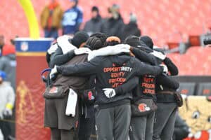 CLEVELAND, OHIO - DECEMBER 07: Shedeur Sanders #12 of the Cleveland Browns huddles with the wide receivers prior to a game against the Tennessee Titans at Huntington Bank Field on December 07, 2025 in Cleveland, Ohio.