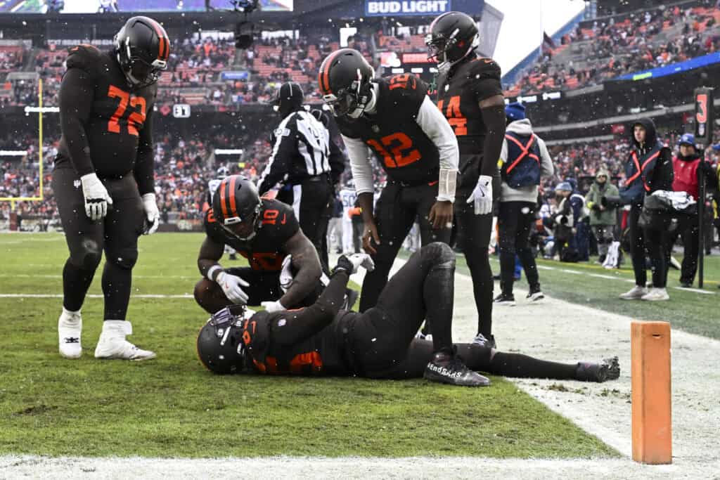CLEVELAND, OHIO - DECEMBER 07: David Njoku #85 of the Cleveland Browns reacts after catching a touchdown in front of Darrell Baker Jr. #39 of the Tennessee Titans during the second quarter at Huntington Bank Field on December 07, 2025 in Cleveland, Ohio.