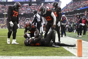 CLEVELAND, OHIO - DECEMBER 07: David Njoku #85 of the Cleveland Browns reacts after catching a touchdown in front of Darrell Baker Jr. #39 of the Tennessee Titans during the second quarter at Huntington Bank Field on December 07, 2025 in Cleveland, Ohio.