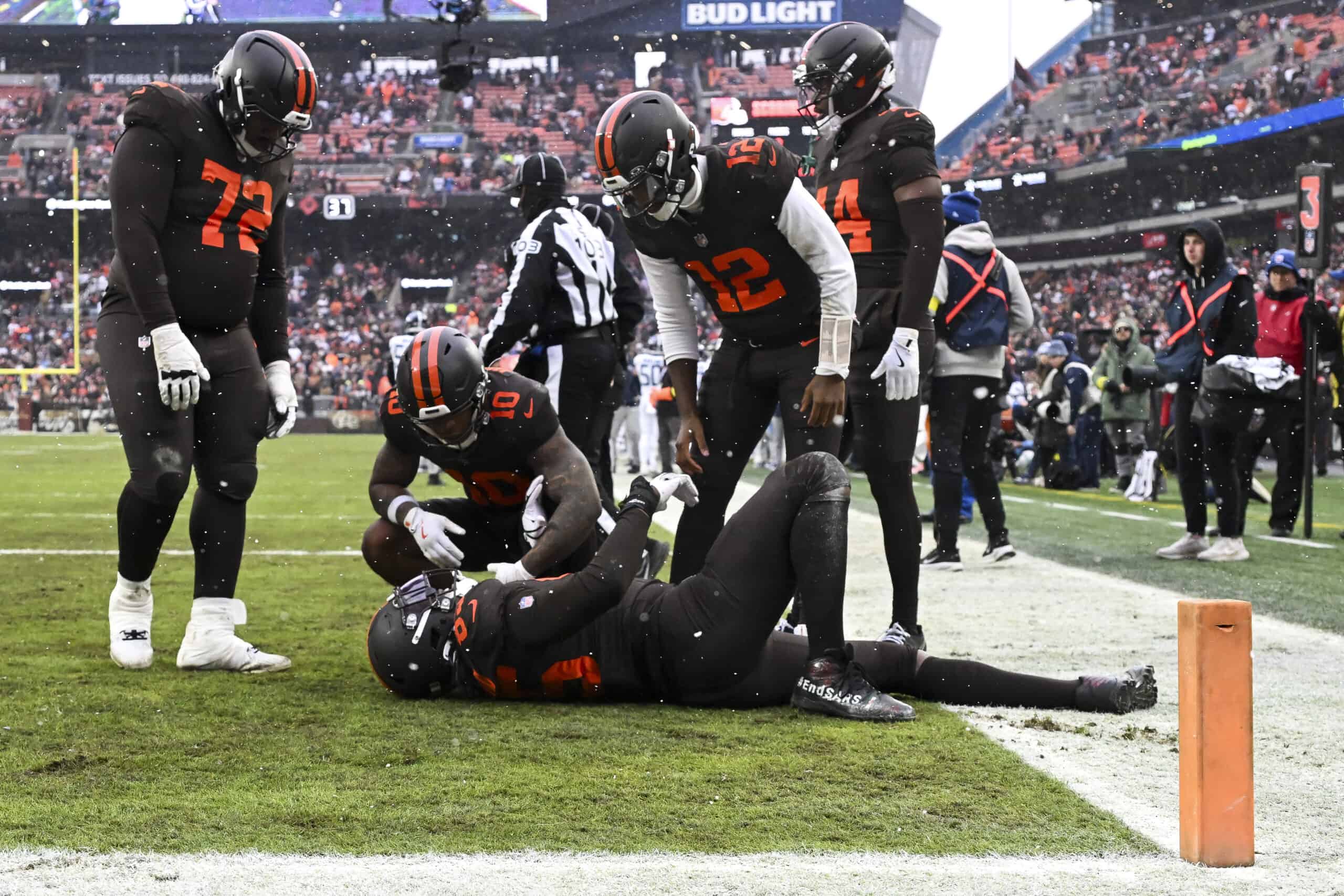 CLEVELAND, OHIO - DECEMBER 07: David Njoku #85 of the Cleveland Browns reacts after catching a touchdown in front of Darrell Baker Jr. #39 of the Tennessee Titans during the second quarter at Huntington Bank Field on December 07, 2025 in Cleveland, Ohio.
