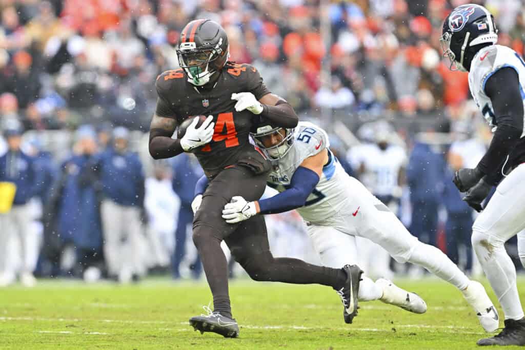 CLEVELAND, OHIO - DECEMBER 07: Harold Fannin Jr. #44 of the Cleveland Browns runs with the ball as Truman Jones #56 of the Tennessee Titans attempts a tackle during the first half Huntington Bank Field on December 07, 2025 in Cleveland, Ohio. 