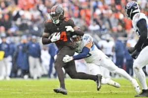 CLEVELAND, OHIO - DECEMBER 07: Harold Fannin Jr. #44 of the Cleveland Browns runs with the ball as Truman Jones #56 of the Tennessee Titans attempts a tackle during the first half Huntington Bank Field on December 07, 2025 in Cleveland, Ohio.