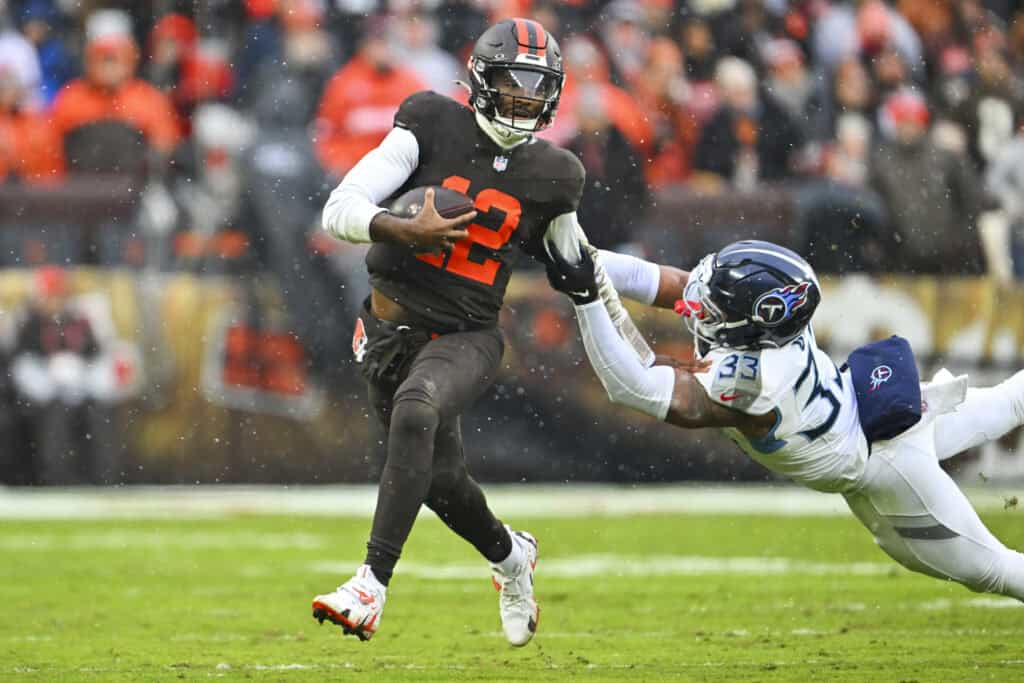 CLEVELAND, OHIO - DECEMBER 07: Shedeur Sanders #12 of the Cleveland Browns is tackled by Cedric Gray #33 of the Tennessee Titans during the second quarter at Huntington Bank Field on December 07, 2025 in Cleveland, Ohio.