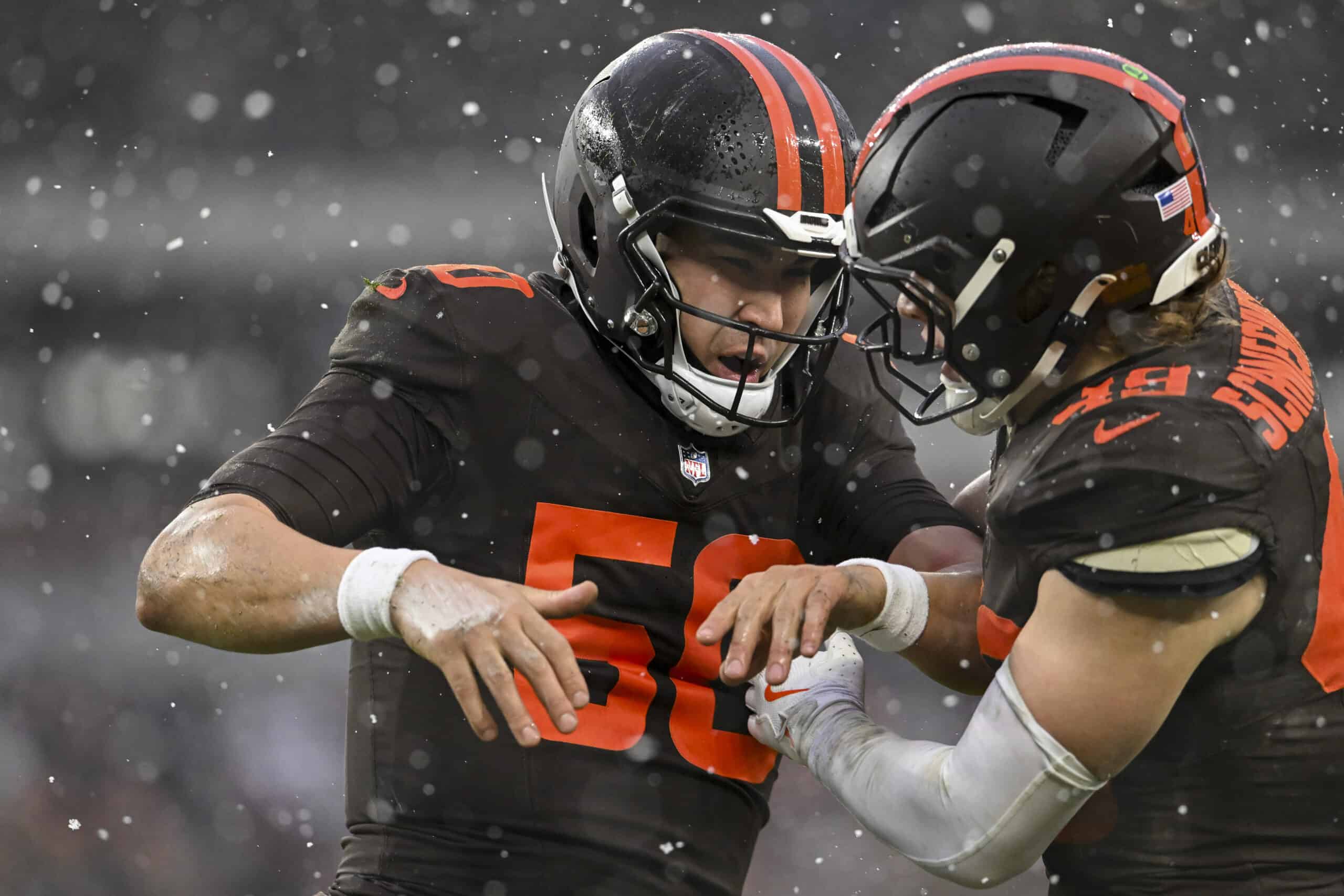 CLEVELAND, OHIO - DECEMBER 07: Rex Sunahara #50 celebrates a tackle with Carson Schwesinger #49 of the Cleveland Browns during the fourth quarter against the Tennessee Titans at Huntington Bank Field on December 07, 2025 in Cleveland, Ohio.