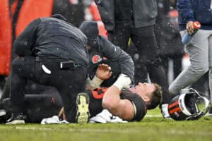 CLEVELAND, OHIO - DECEMBER 07: Ethan Pocic #55 of the Cleveland Browns reacts after an injury during the fourth quarter against the Tennessee Titans at Huntington Bank Field on December 07, 2025 in Cleveland, Ohio.