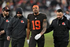 CLEVELAND, OHIO - DECEMBER 07: Cedric Tillman #19 of the Cleveland Browns is helped off the field after being injured during the fourth quarter against the Tennessee Titans at Huntington Bank Field on December 07, 2025 in Cleveland, Ohio.
