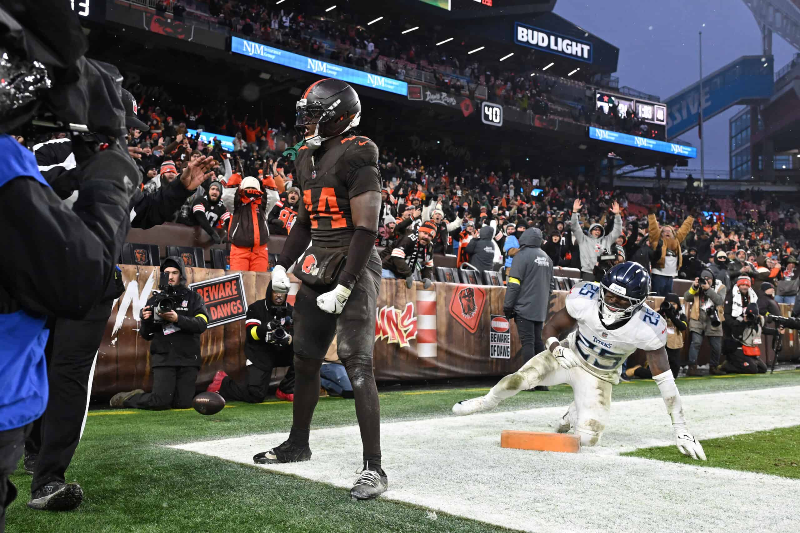 CLEVELAND, OHIO - DECEMBER 07: Harold Fannin Jr. #44 of the Cleveland Browns celebrates after catcheinga pass in front of Xavier Woods #25 of the Tennessee Titans for a touchdown during the fourth quarter at Huntington Bank Field on December 07, 2025 in Cleveland, Ohio.