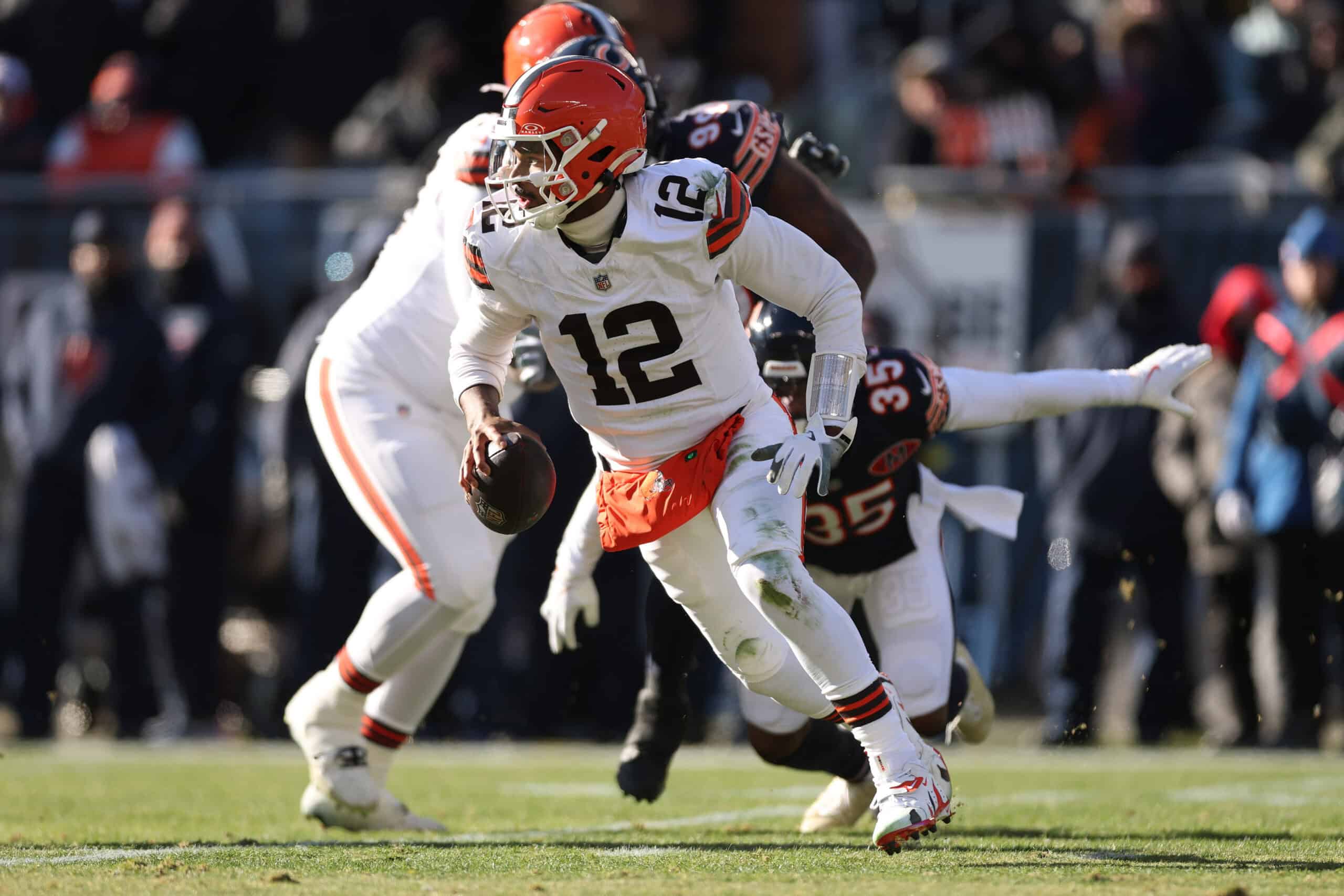 CHICAGO, ILLINOIS - DECEMBER 14: Shedeur Sanders #12 of the Cleveland Browns scrambles during the first quarter against the Chicago Bears at Soldier Field on December 14, 2025 in Chicago, Illinois.