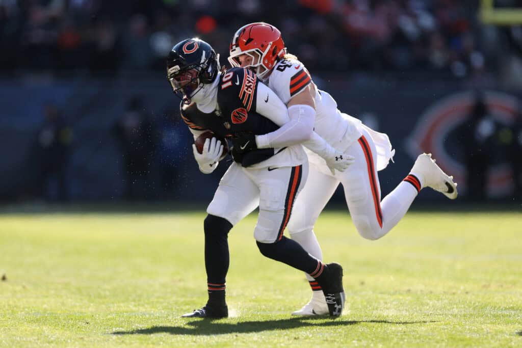 CHICAGO, ILLINOIS - DECEMBER 14: Carson Schwesinger #49 of the Cleveland Browns tackles Luther Burden III #10 of the Chicago Bears during the first quarter at Soldier Field on December 14, 2025 in Chicago, Illinois.