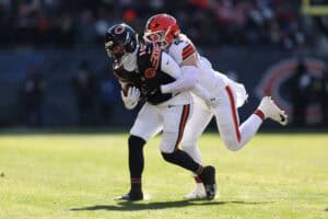 CHICAGO, ILLINOIS - DECEMBER 14: Carson Schwesinger #49 of the Cleveland Browns tackles Luther Burden III #10 of the Chicago Bears during the first quarter at Soldier Field on December 14, 2025 in Chicago, Illinois.