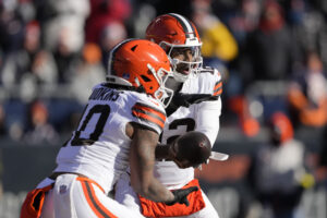 CHICAGO, ILLINOIS - DECEMBER 14: Shedeur Sanders #12 hands off to Quinshon Judkins #10 of the Cleveland Browns during the first half against the Chicago Bears on December 14, 2025 in Chicago, Illinois.