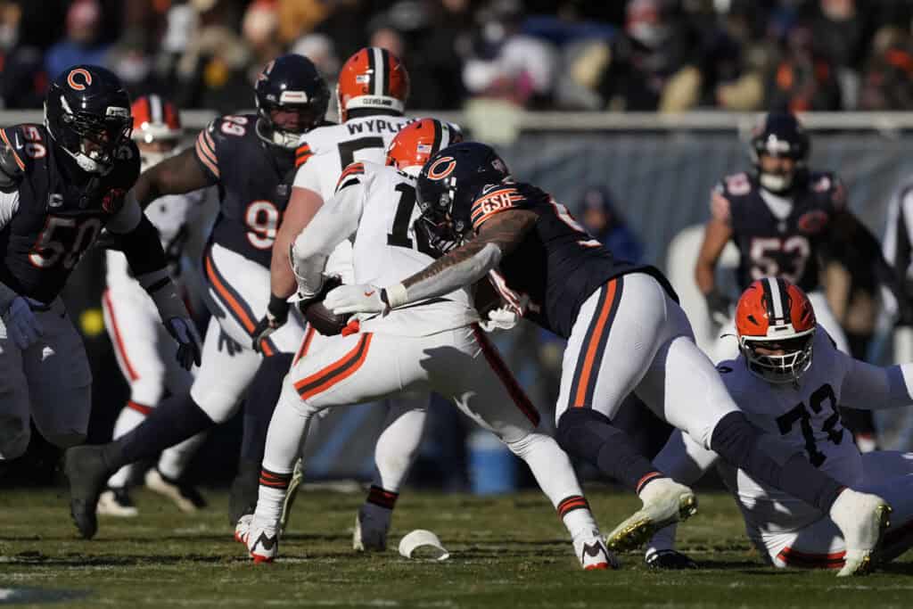 CHICAGO, ILLINOIS - DECEMBER 14: Austin Booker #94 of the Chicago Bears sacks Shedeur Sanders #12 of the Cleveland Browns during the second quarter on December 14, 2025 in Chicago, Illinois.
