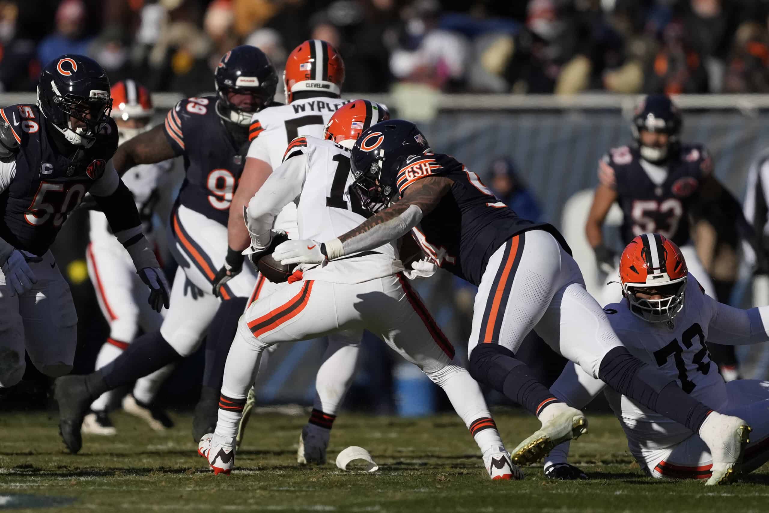 CHICAGO, ILLINOIS - DECEMBER 14: Austin Booker #94 of the Chicago Bears sacks Shedeur Sanders #12 of the Cleveland Browns during the second quarter on December 14, 2025 in Chicago, Illinois.