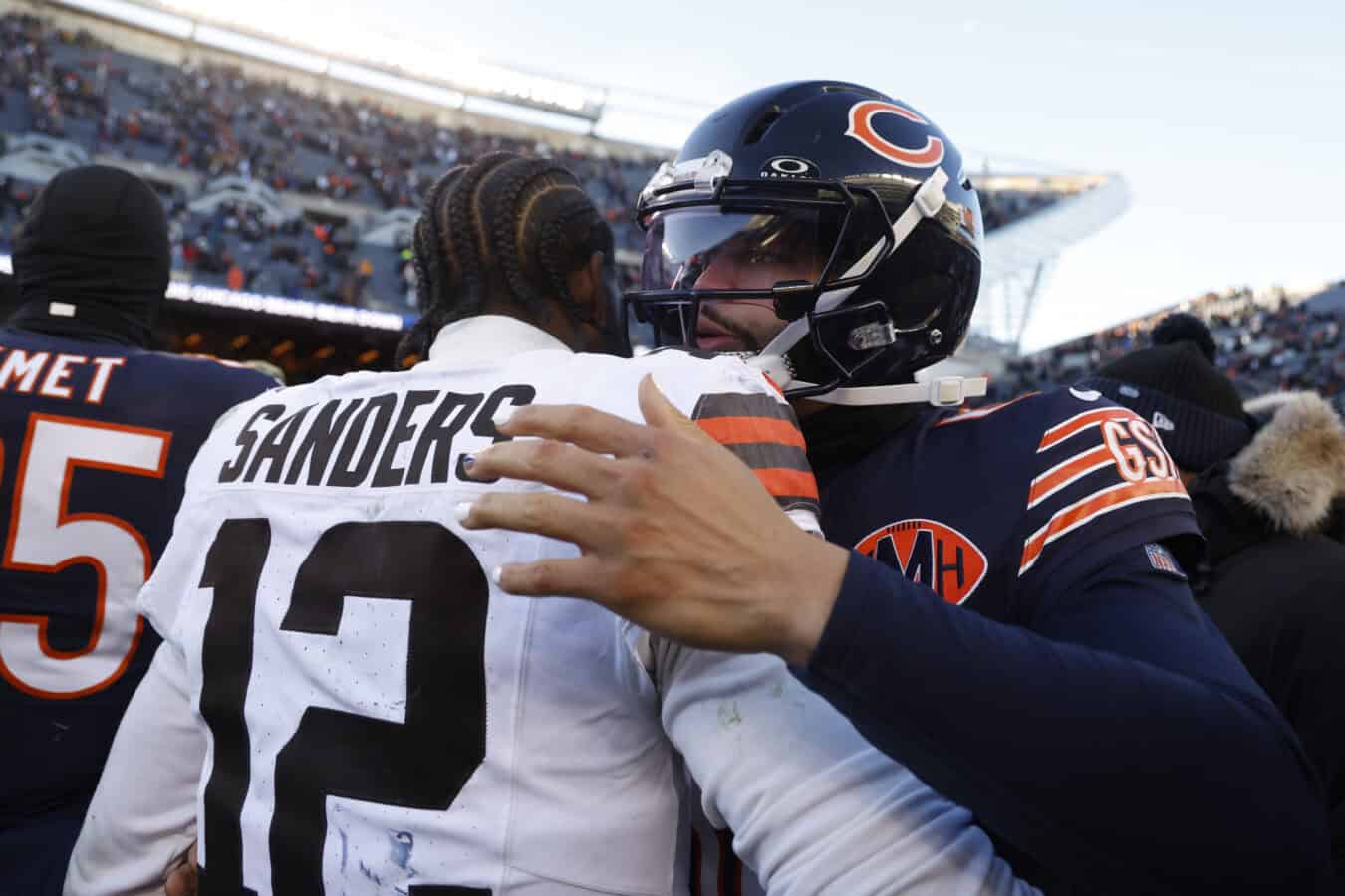 CHICAGO, ILLINOIS - DECEMBER 14: Caleb Williams #18 of the Chicago Bears and Shedeur Sanders #12 of the Cleveland Browns meet after the game at Soldier Field on December 14, 2025 in Chicago, Illinois. The Bears beat the Browns 31-3.