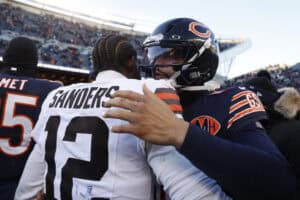 CHICAGO, ILLINOIS - DECEMBER 14: Caleb Williams #18 of the Chicago Bears and Shedeur Sanders #12 of the Cleveland Browns meet after the game at Soldier Field on December 14, 2025 in Chicago, Illinois. The Bears beat the Browns 31-3.