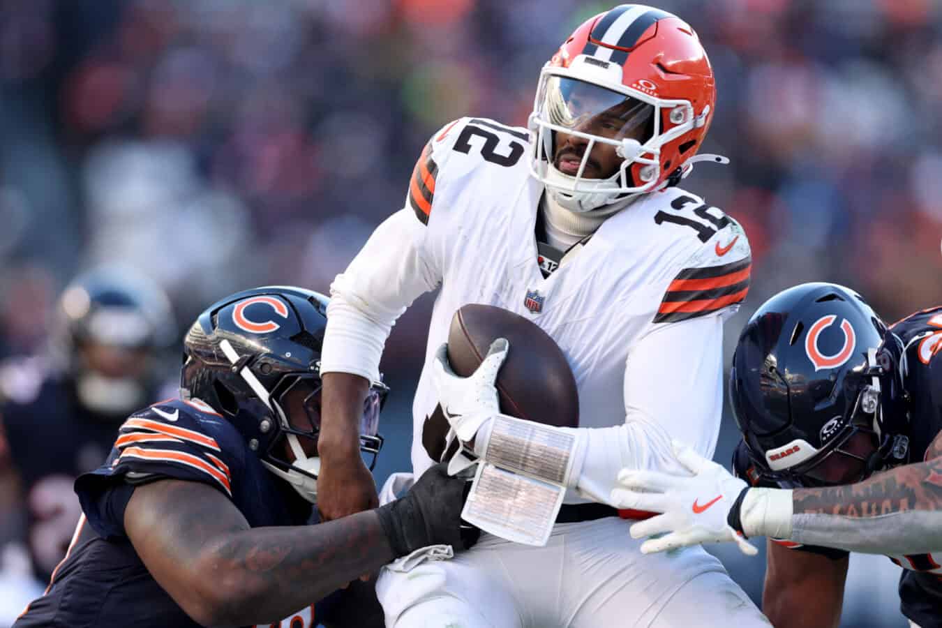 CHICAGO, ILLINOIS - DECEMBER 14: Shedeur Sanders #12 of the Cleveland Browns is sacked during the third quarter against the Chicago Bears at Soldier Field on December 14, 2025 in Chicago, Illinois.