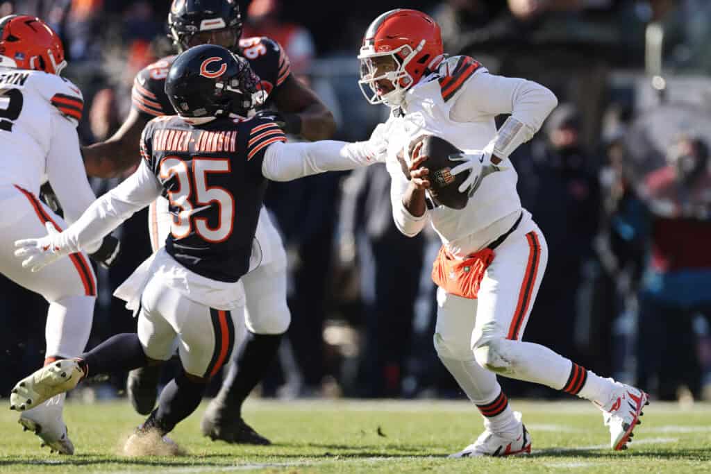 CHICAGO, ILLINOIS - DECEMBER 14: Shedeur Sanders #12 of the Cleveland Browns scrambles during the first quarter against the Chicago Bears at Soldier Field on December 14, 2025 in Chicago, Illinois.