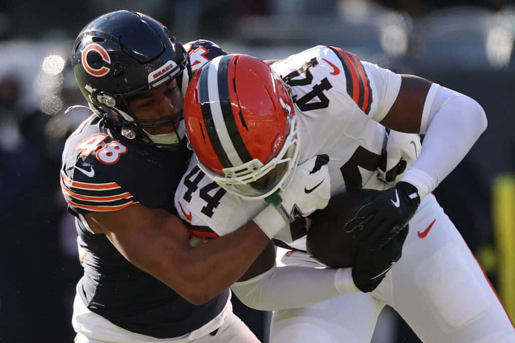 CHICAGO, ILLINOIS - DECEMBER 14: D'Marco Jackson #48 of the Chicago Bears tackles Harold Fannin Jr. #44 of the Cleveland Browns at Soldier Field on December 14, 2025 in Chicago, Illinois