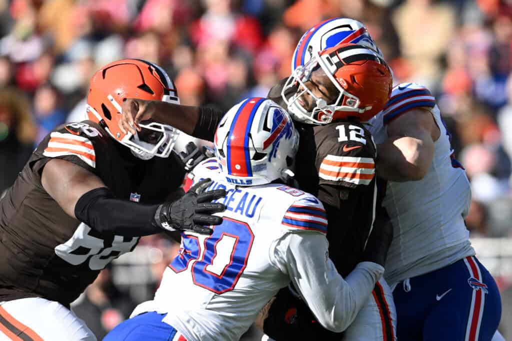 CLEVELAND, OHIO - DECEMBER 21: Shedeur Sanders #12 of the Cleveland Browns is tackled by the defense of the Buffalo Bills after a throw in the first quarter of the game at Huntington Bank Field on December 21, 2025 in Cleveland, Ohio.