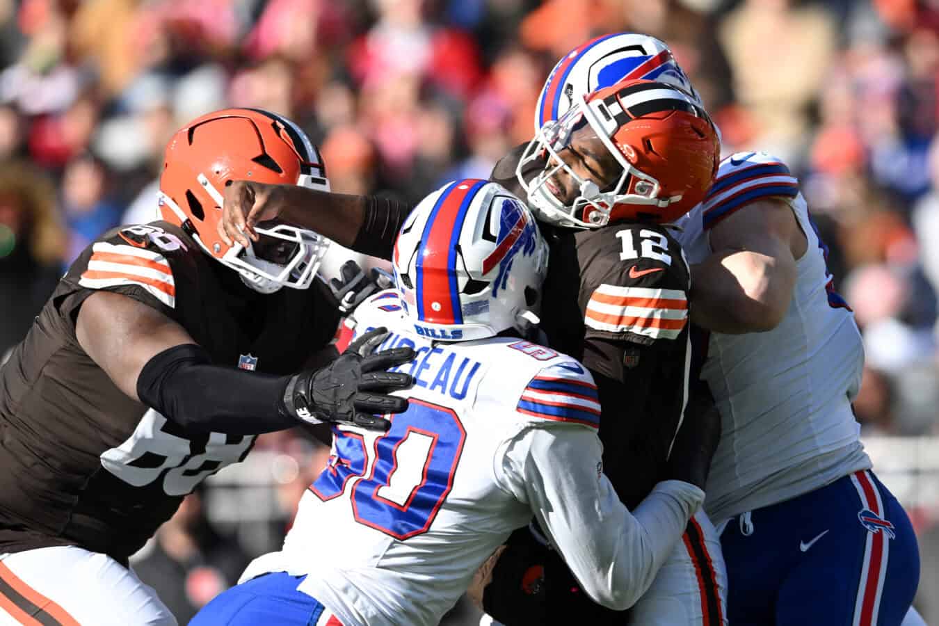 CLEVELAND, OHIO - DECEMBER 21: Shedeur Sanders #12 of the Cleveland Browns is tackled by the defense of the Buffalo Bills after a throw in the first quarter of the game at Huntington Bank Field on December 21, 2025 in Cleveland, Ohio.