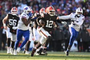 CLEVELAND, OHIO - DECEMBER 21: Shedeur Sanders #12 of the Cleveland Browns carries the ball against the defense of the Buffalo Bills in the third quarter of the game at Huntington Bank Field on December 21, 2025 in Cleveland, Ohio.