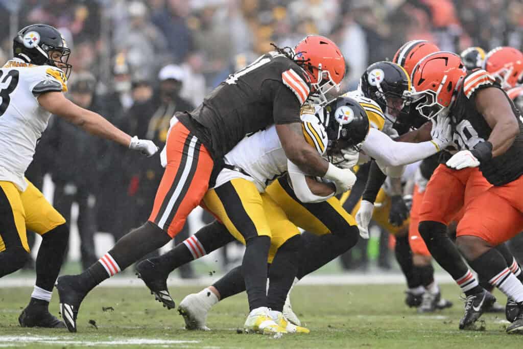 CLEVELAND, OHIO - DECEMBER 28: Alex Wright #91 of the Cleveland Browns tackles Kenneth Gainwell #14 of the Pittsburgh Steelers on the kick return during the first quarter of the game at Huntington Bank Field on December 28, 2025 in Cleveland, Ohio.